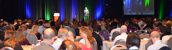 NWCDC conference photo with speaker onstage addressing audience - source: wcconference.com